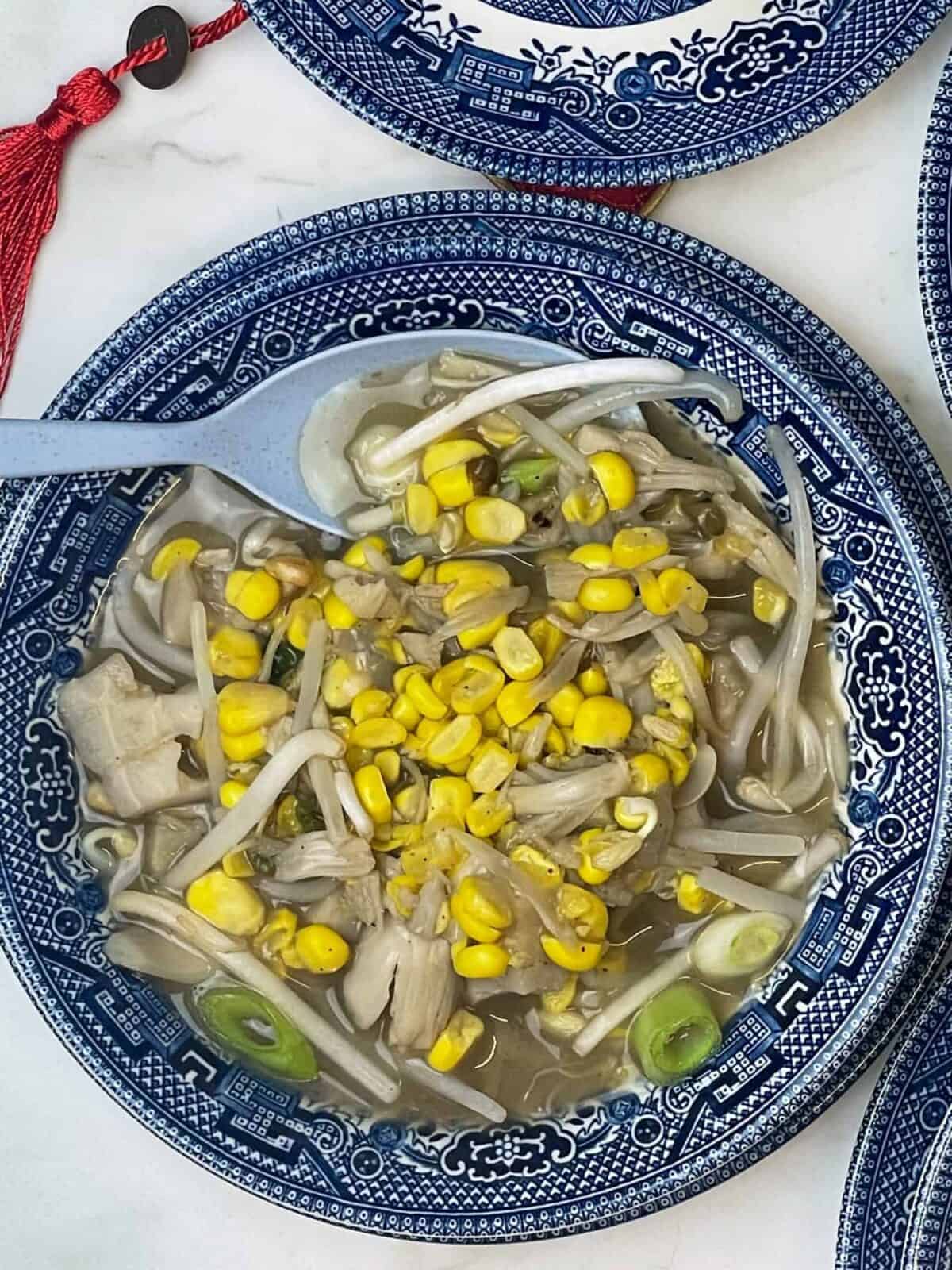 Soup served in blue patterned bowl with blue spoon, featured image.