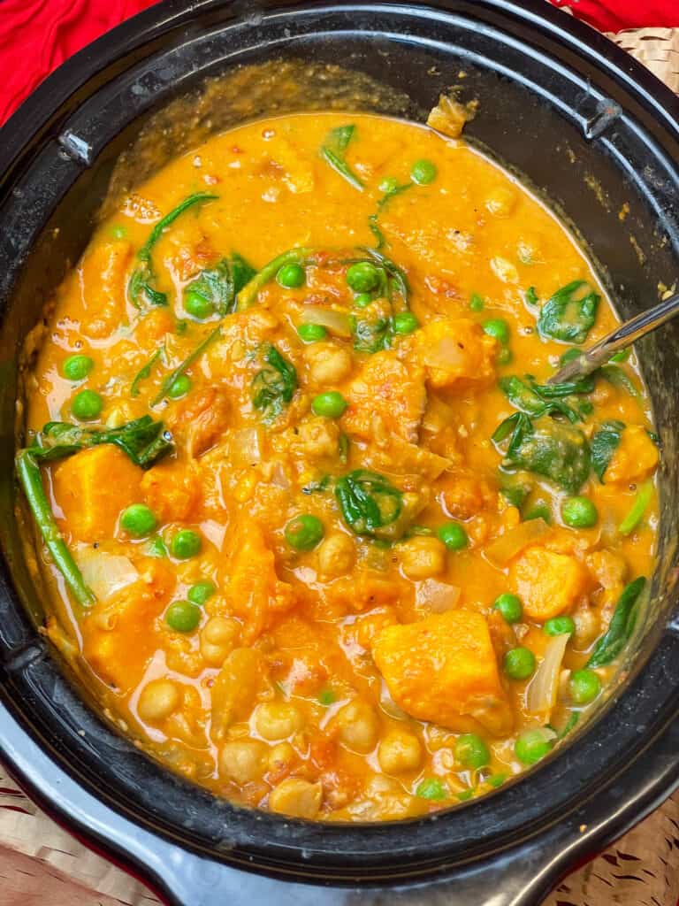 Thai curry ready to serve in slow cooker with lid removed.