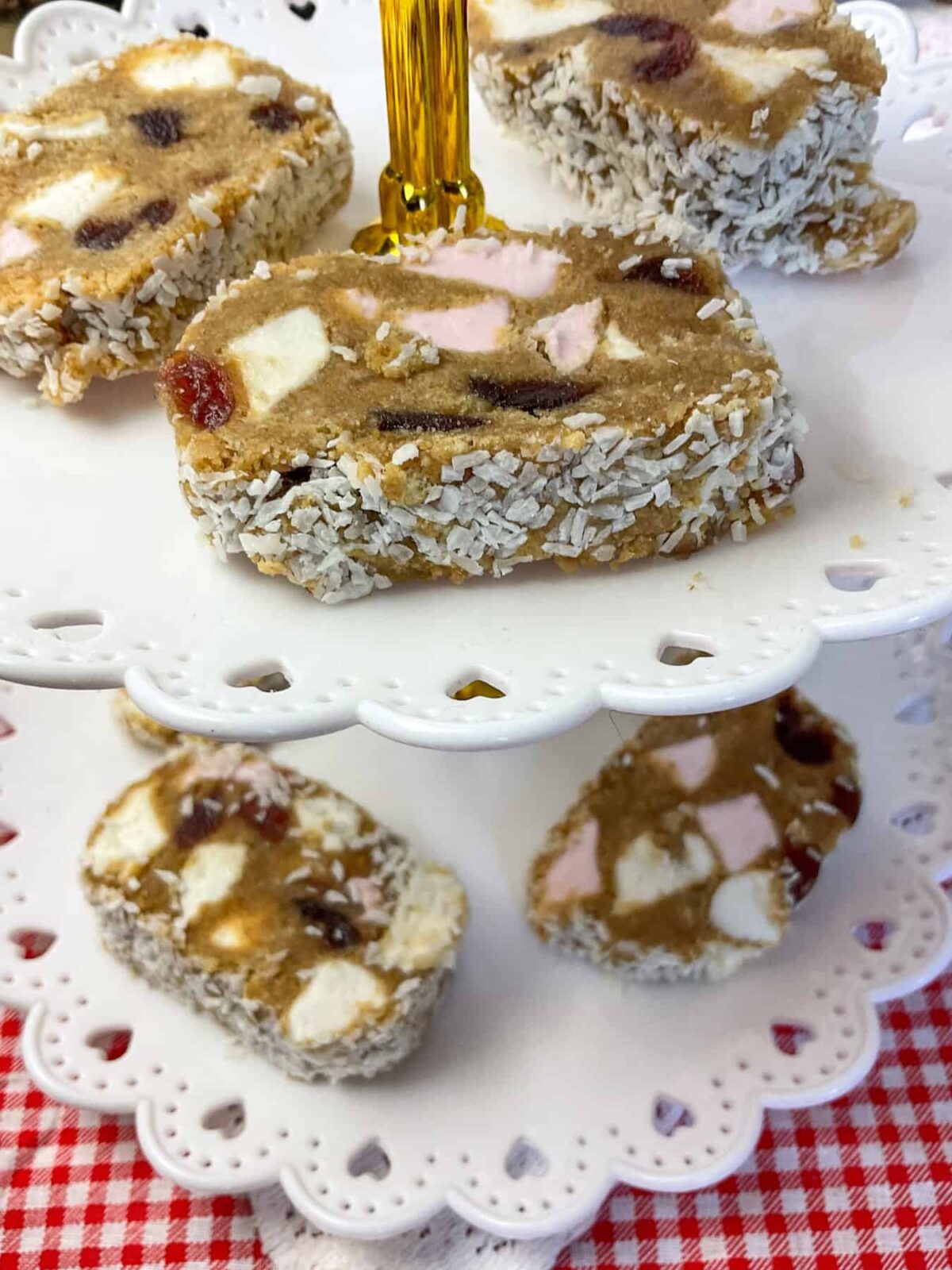 vegan fifteens on a white cake tiered stand with red and white check tablecloth.