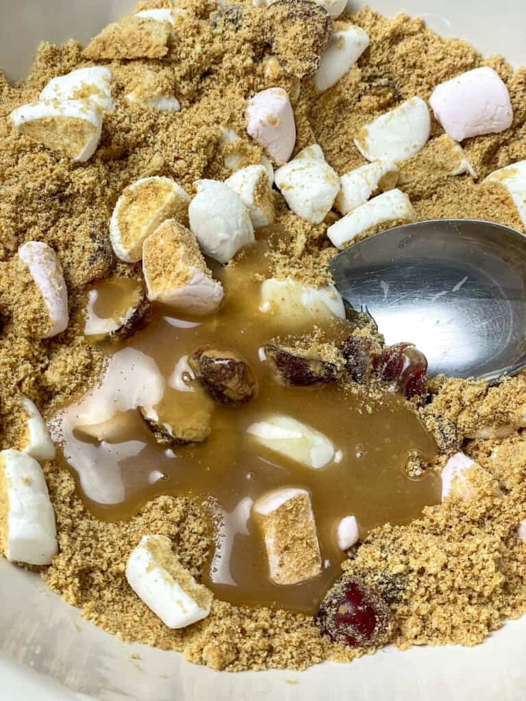 vegan condensed milk poured into the fifteens ingredients in mixing bowl.
