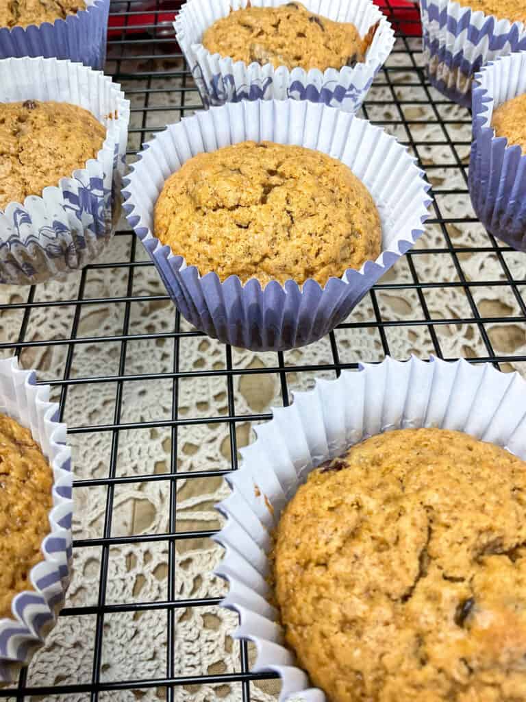 close up of treacle buns cooling on wire rack with coloured doily underneath.