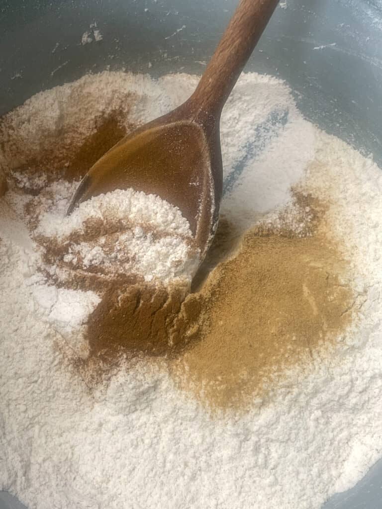 spices and sugar added to flour in mixing bowl.