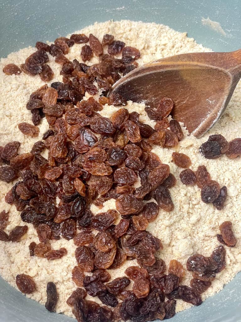 sultanas added to flour mixture in bowl.