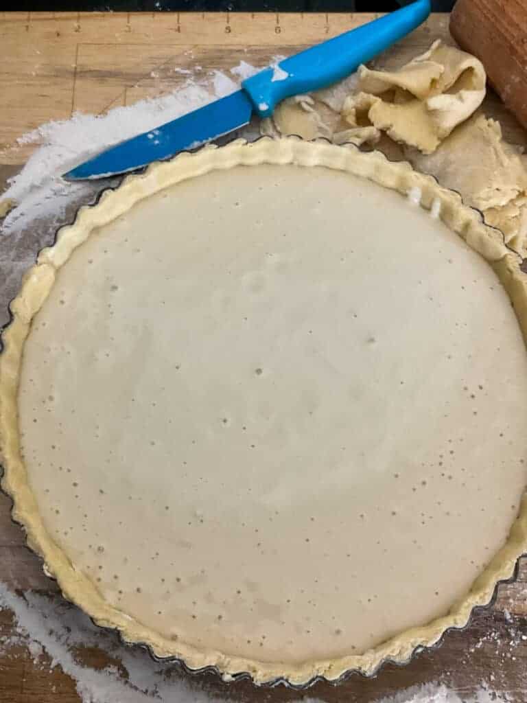 Filling poured into cheese flan pastry case.