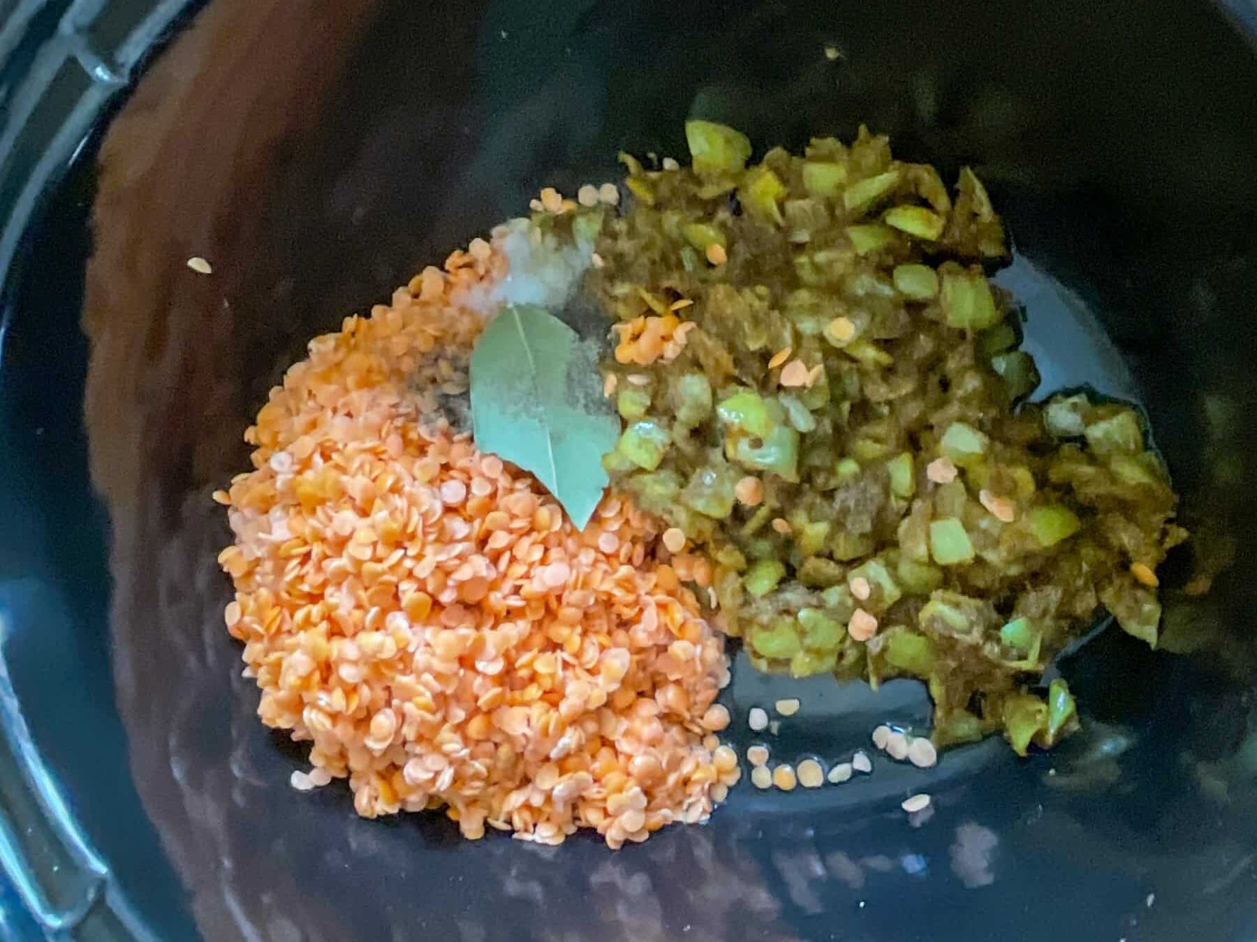 Lentils and cooked onions mixture in slow cooker.