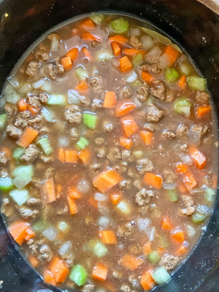 stock added to mince mixture in slow cooker.