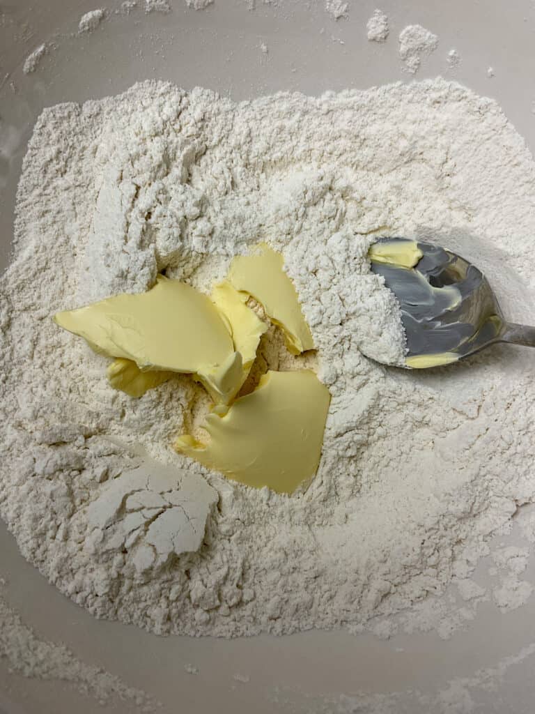 flour and margarine added to mixing bowl for cobbler topping.