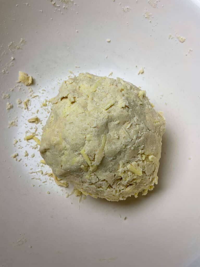cobbler scone dough in a ball in mixing bowl.