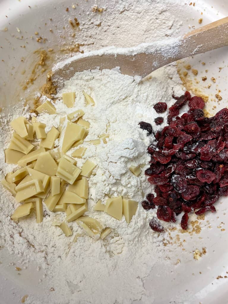 White chocolate and dried cranberries added to mixing bowl.