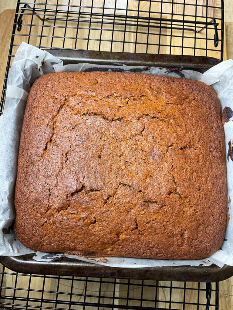 baked applesauce cake on a wire rack.