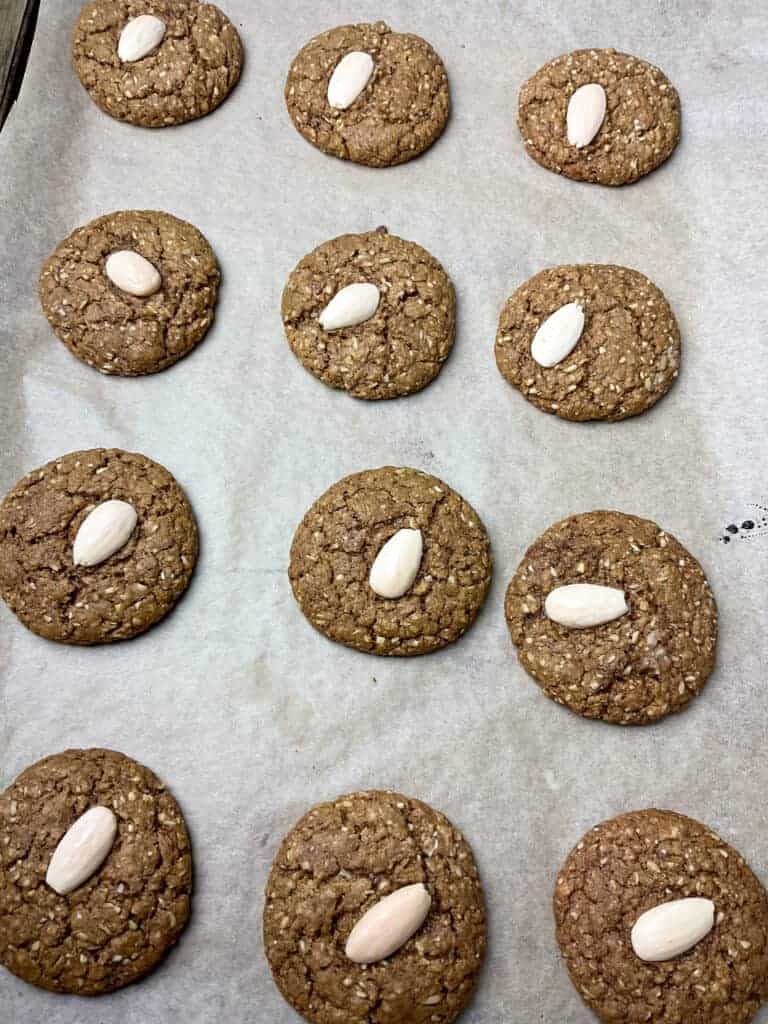 Batch of baked parkin biscuits on baking tray.