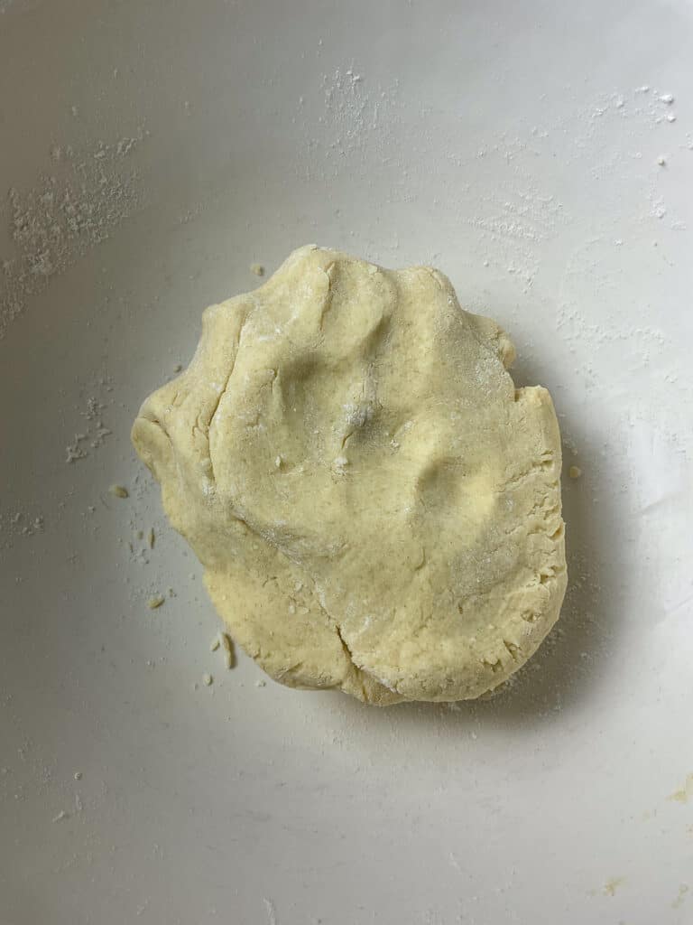 Shortcrust pastry brought together into a pastry dough in the mixing bowl.