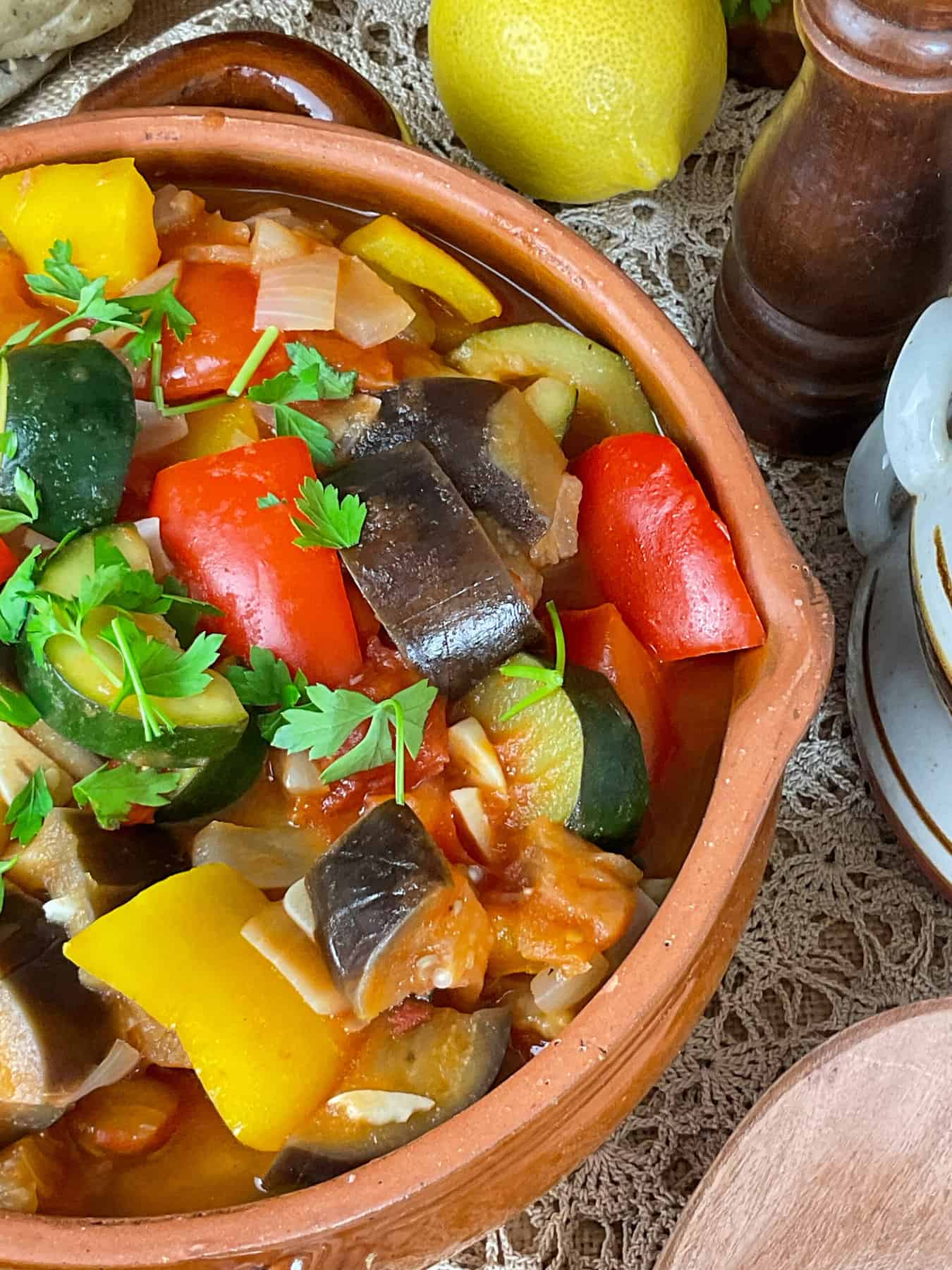 Fresh parsley added to ratatouille in serving bowl.
