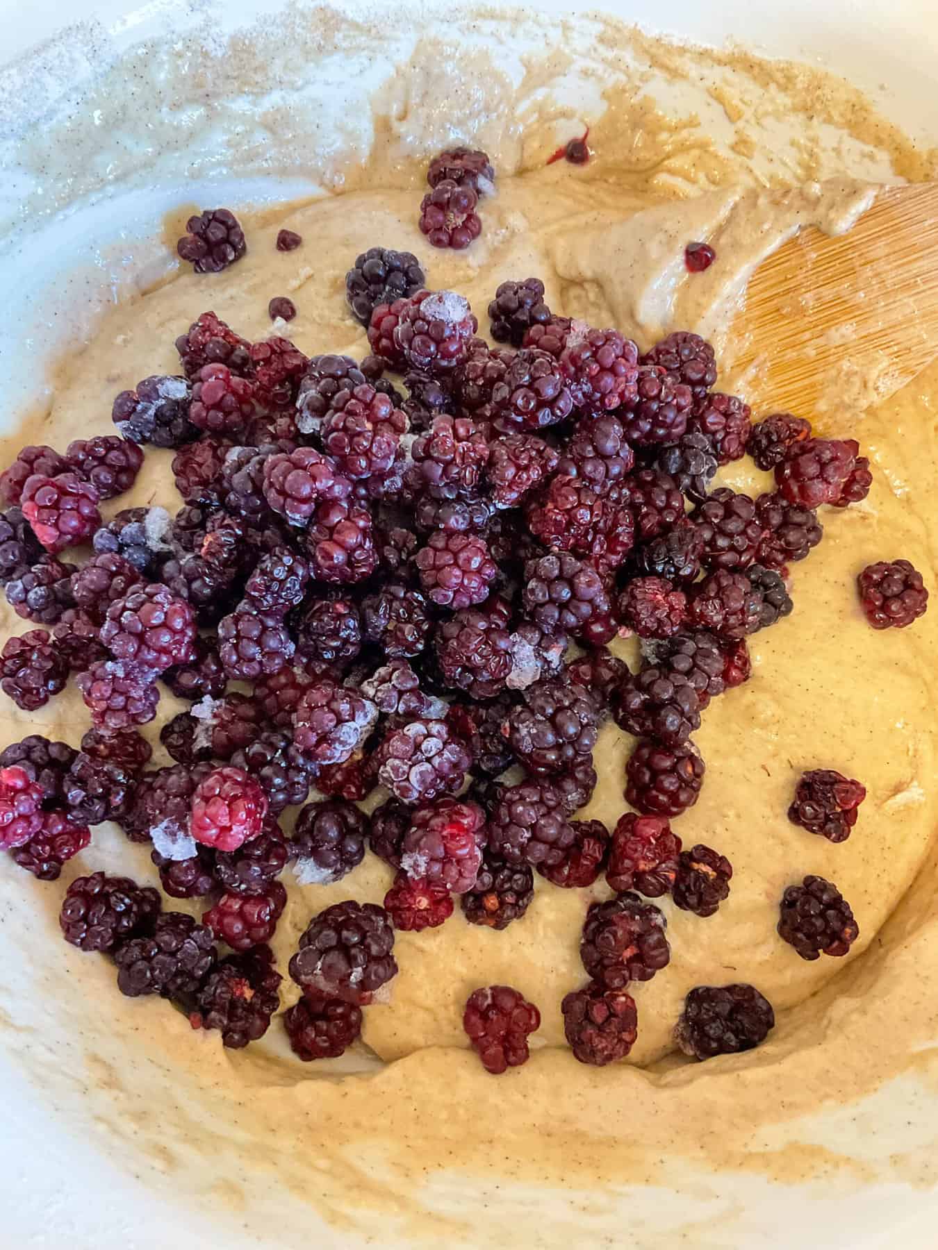 Brambles added to muffin batter in mixing bowl.