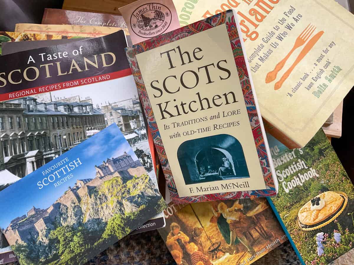 A pile of Scottish cookery books on a table.