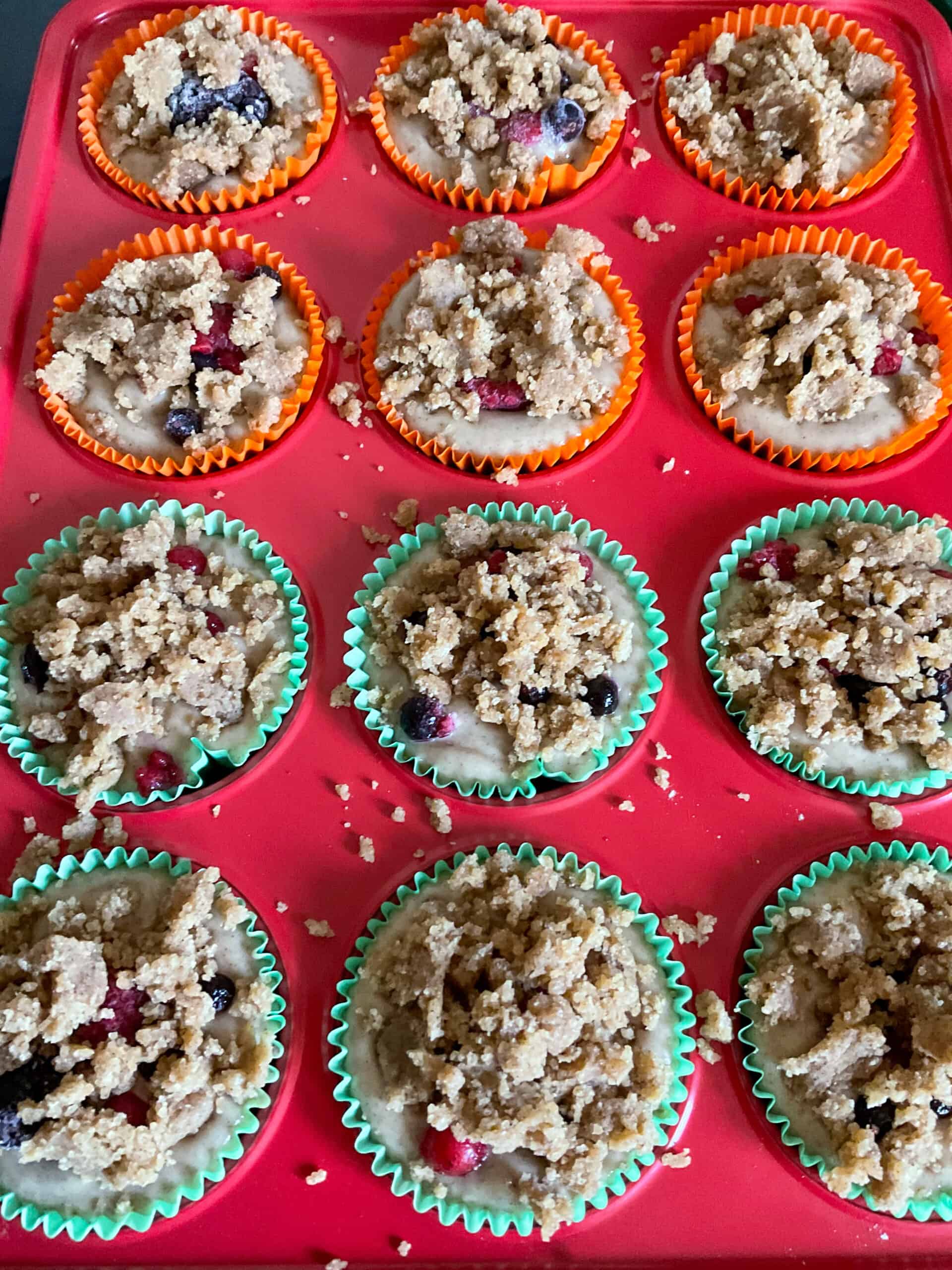 Crumble topping sprinkled over each muffin.