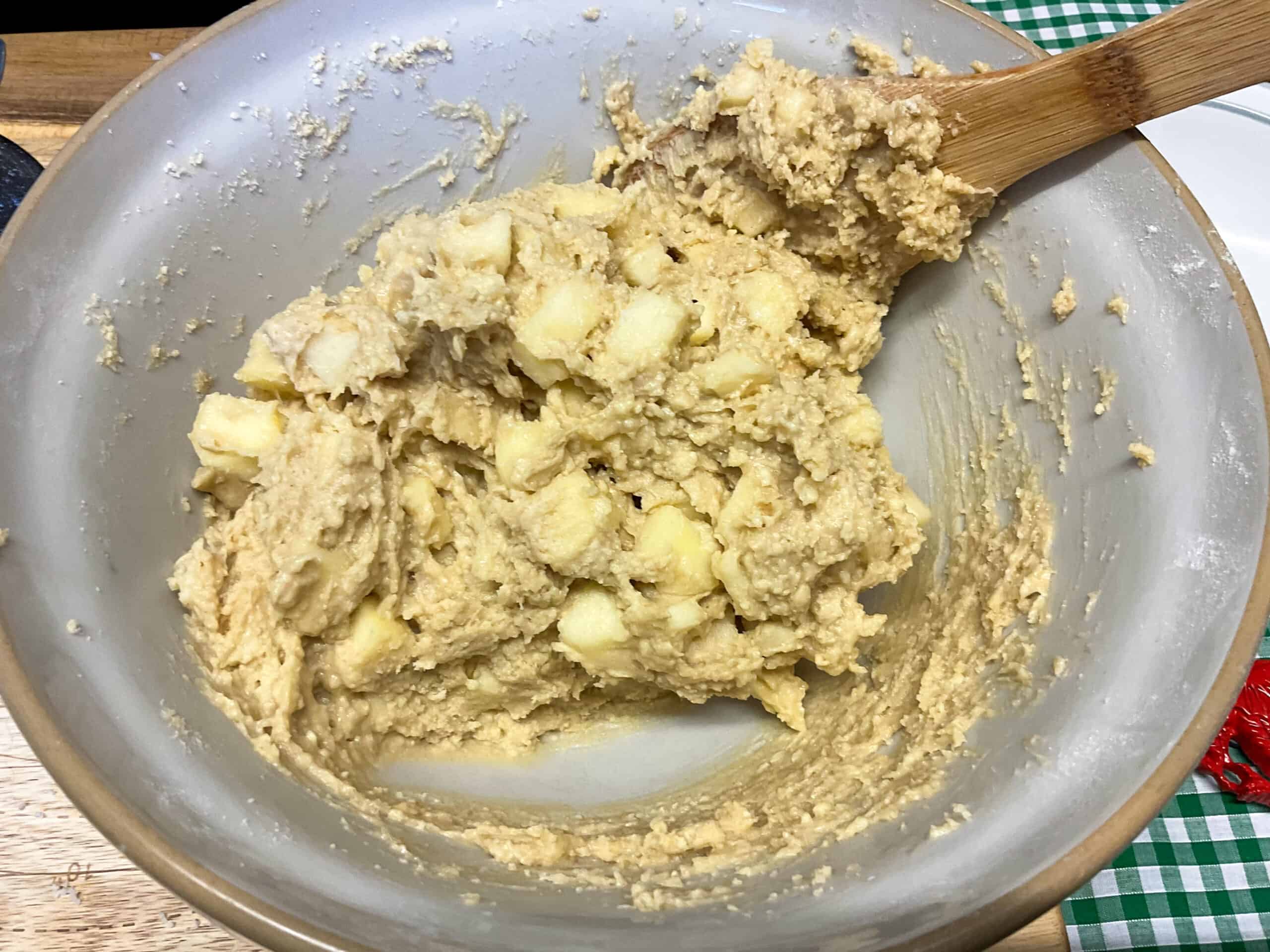 Milk added to cake mixture and stirred to form a firm cake batter in bowl.