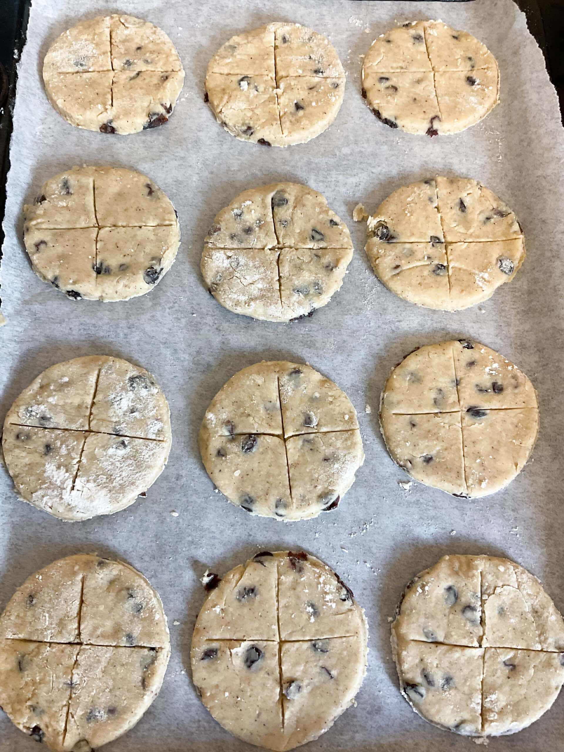 Unbaked soul cakes scored with a cross.