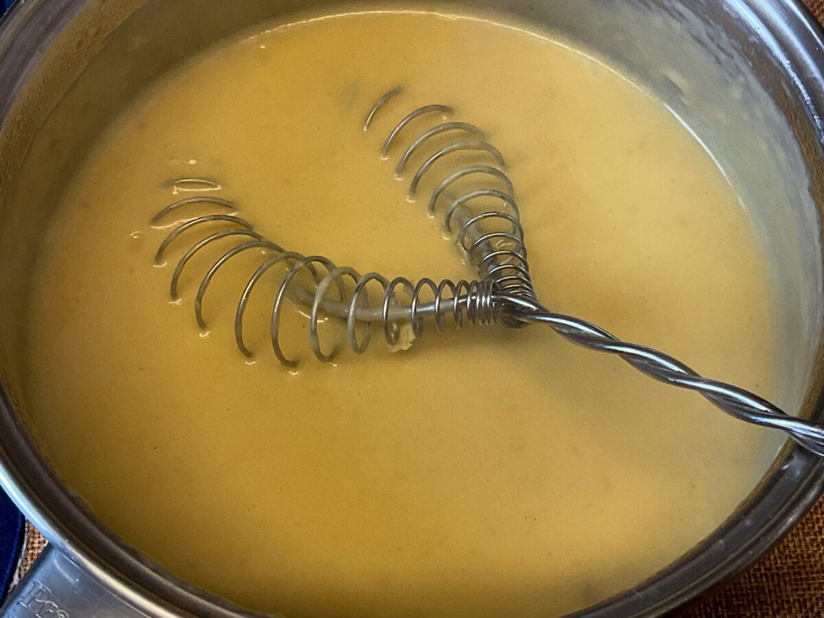 Cheesy sauce ready in saucepan.