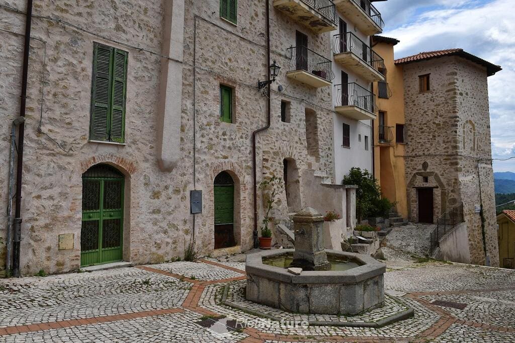 Charming historic Italian village with stone buildings, cobblestone streets, and a central fountain, offering an authentic and picturesque setting in Italy’s scenic countryside.