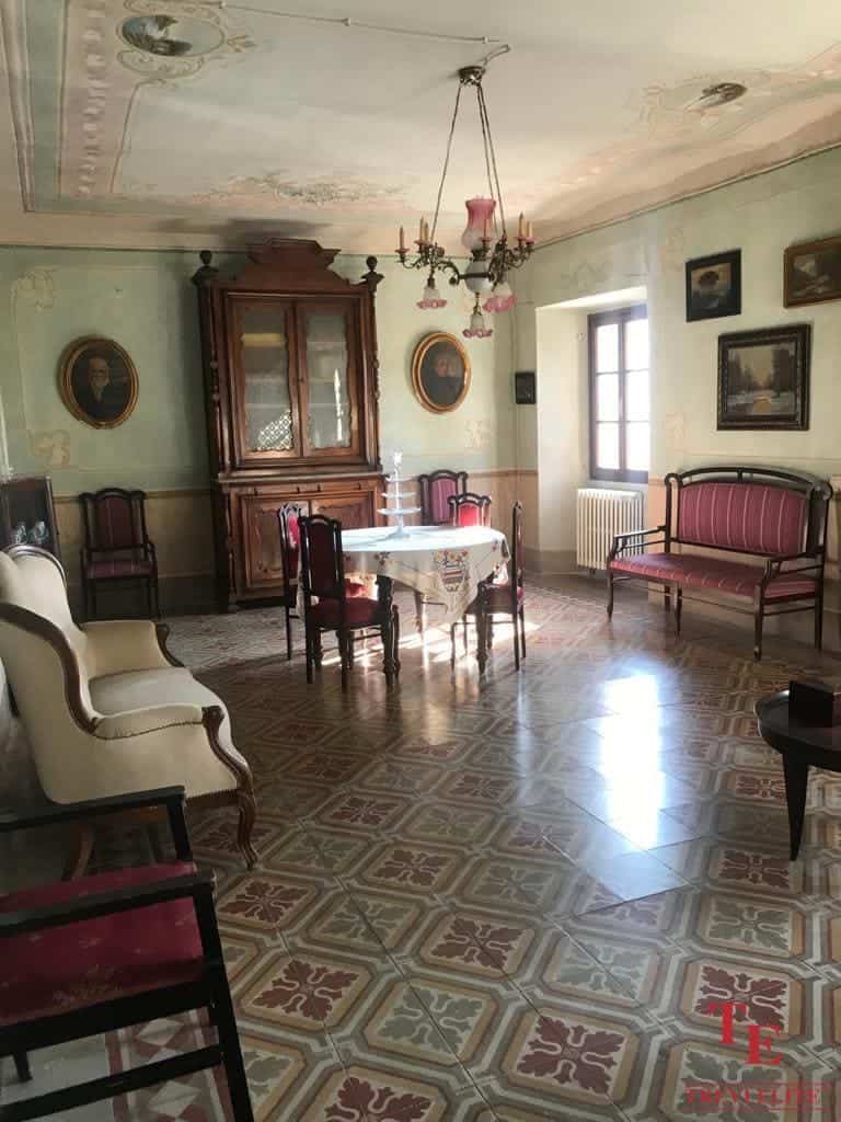 Elegant vintage living room with antique furniture, ornate ceiling, and classic artwork, showcasing luxurious Italian heritage and timeless charm.