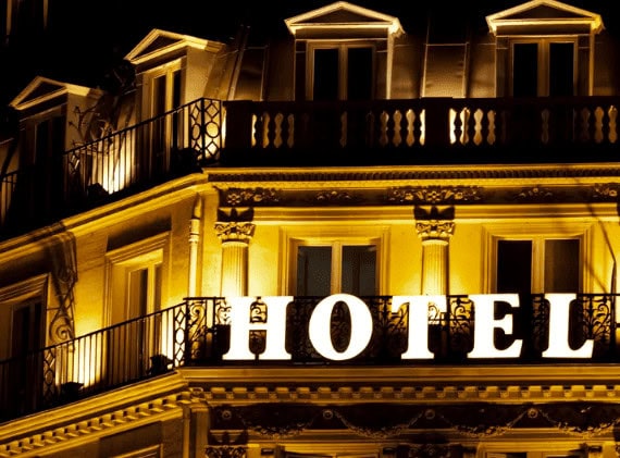 Luxurious illuminated hotel facade at night with classic architecture and elegant lighting, showcasing premium Italian hospitality and real estate excellence.