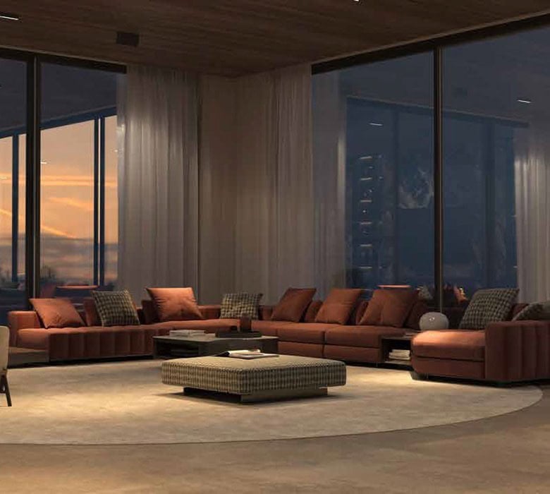 Luxurious modern living room with floor-to-ceiling windows showcasing a city skyline at sunset, featuring stylish furniture, cozy cushions, and elegant decor.