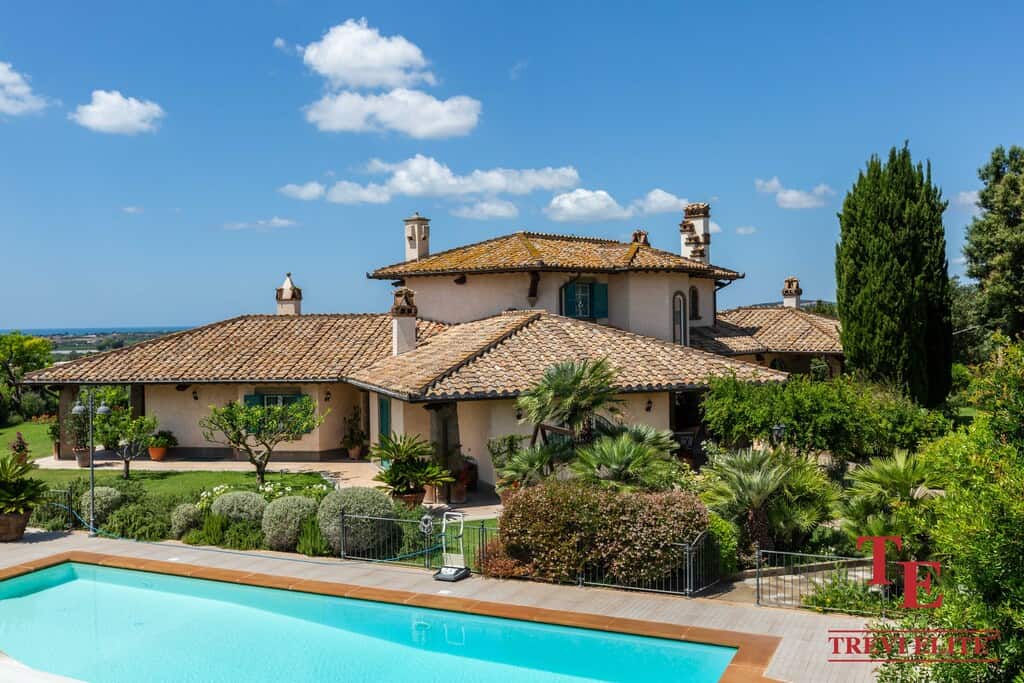 Elegant Italian villa with lush gardens and a private pool, set against a picturesque landscape, blending classic design with modern luxury. For luxury connoisseurs - Trevi Elite.