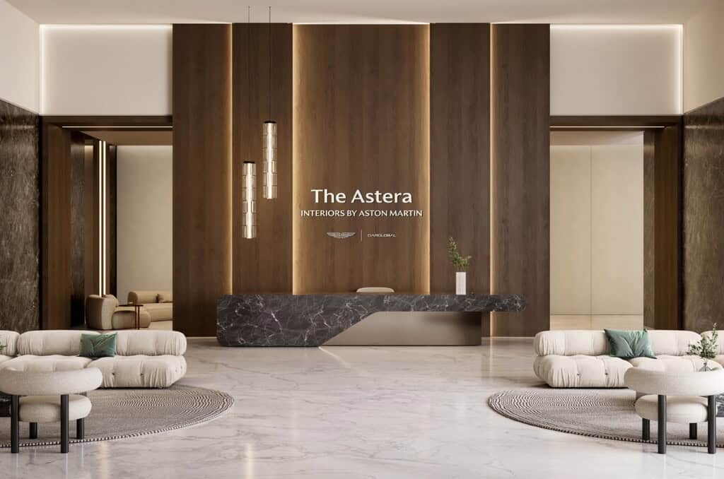 Elegant hotel lobby with modern wooden accents, marble reception desk, and stylish seating area, showcasing luxurious interior design by Aston Martin, in a sophisticated and contemporary setting.
