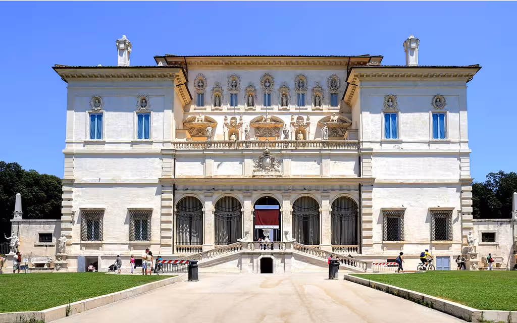 Villa Borghese gallery facade with tourists in Rome, Italy.