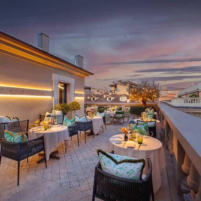 Luxurious rooftop dining terrace in an exclusive Italian property during sunset.