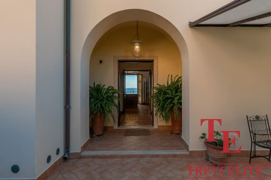 Luxurious Italian interior with classic arches and elegant decor, perfect for upscale real estate listings in Italy.