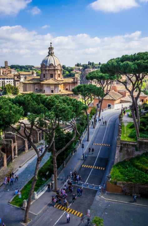 Elegant Italian cityscape featuring historic architecture and lush greenery, ideal for luxury real estate views.