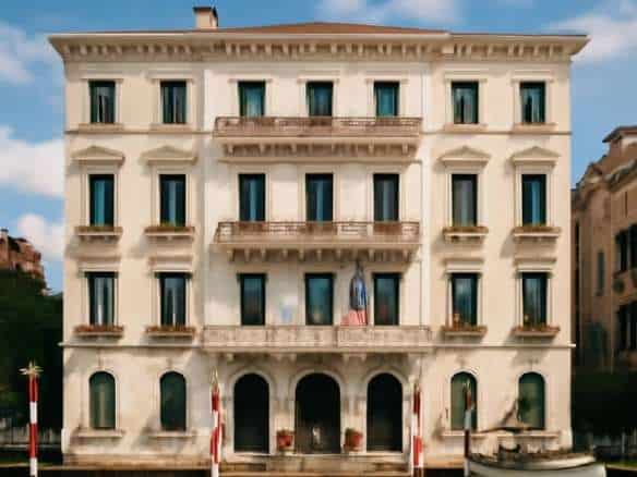 Palatial Italian waterfront building with elegant balconies and classical architecture, situated on a canal in Venice, showcasing luxurious real estate.