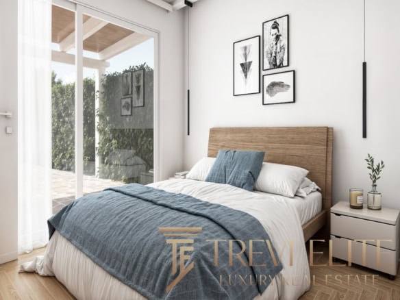 Stylish modern bedroom with minimalist decor, natural light, wooden accents, and elegant artwork, part of a luxurious Italian property offered by Trevi Elite.