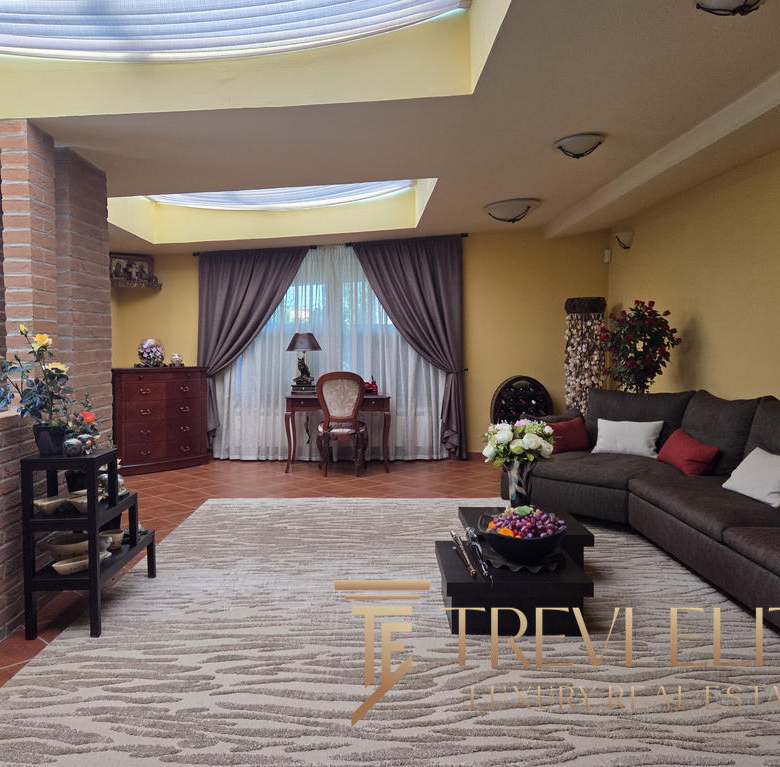 Luxurious Italian living room with elegant furnishings, warm colour palette, and natural light, showcasing premium real estate properties by Trevi Elite in Italy.