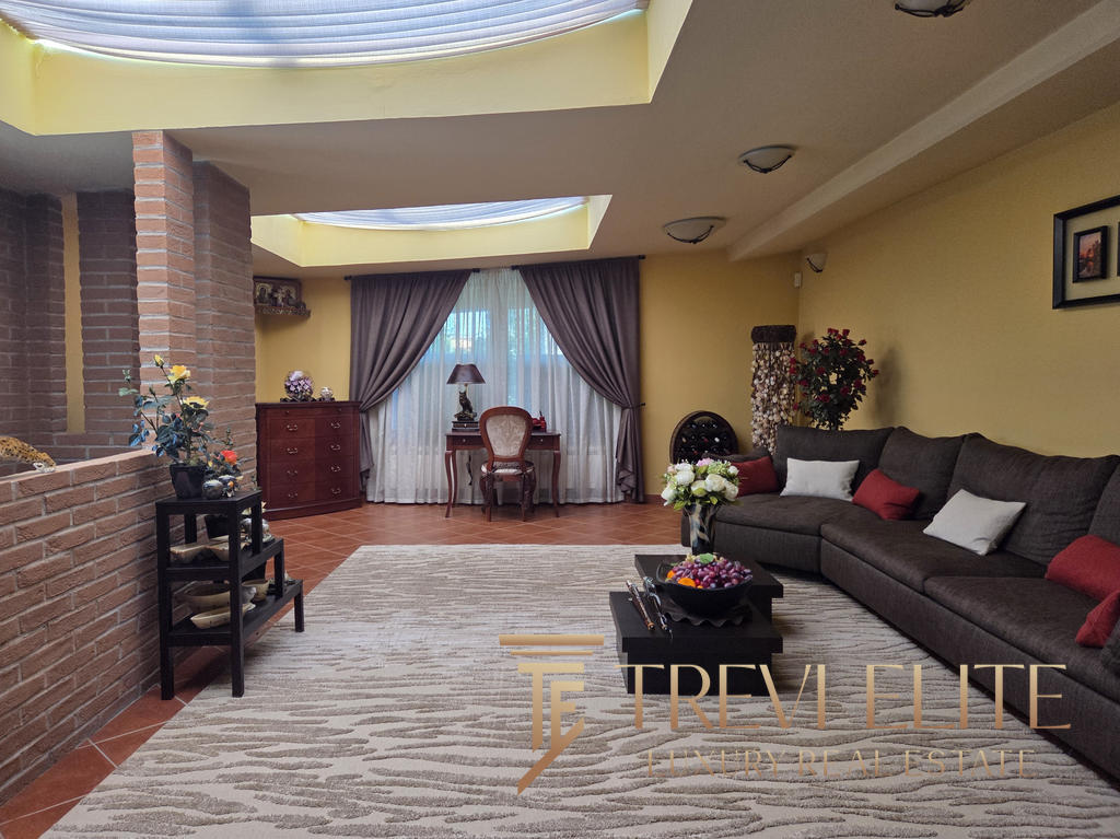 Luxurious Italian living room with elegant furnishings, warm colour palette, and natural light, showcasing premium real estate properties by Trevi Elite in Italy.