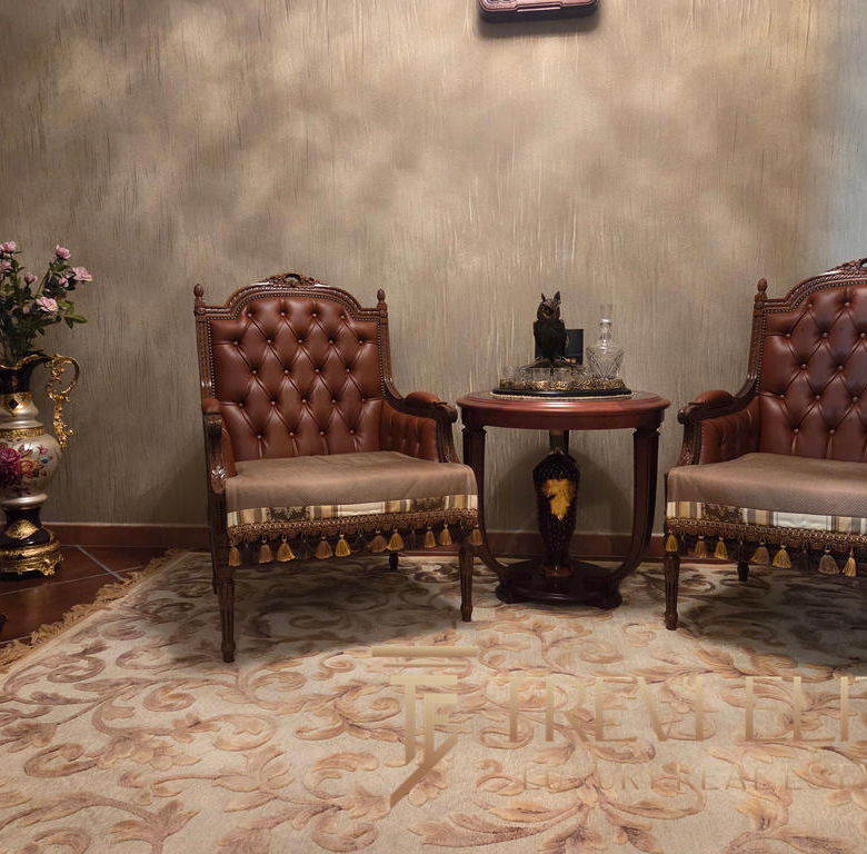 Luxurious antique-style armchairs with tufted leather upholstery and ornate wooden details in a classic Italian interior setting.
