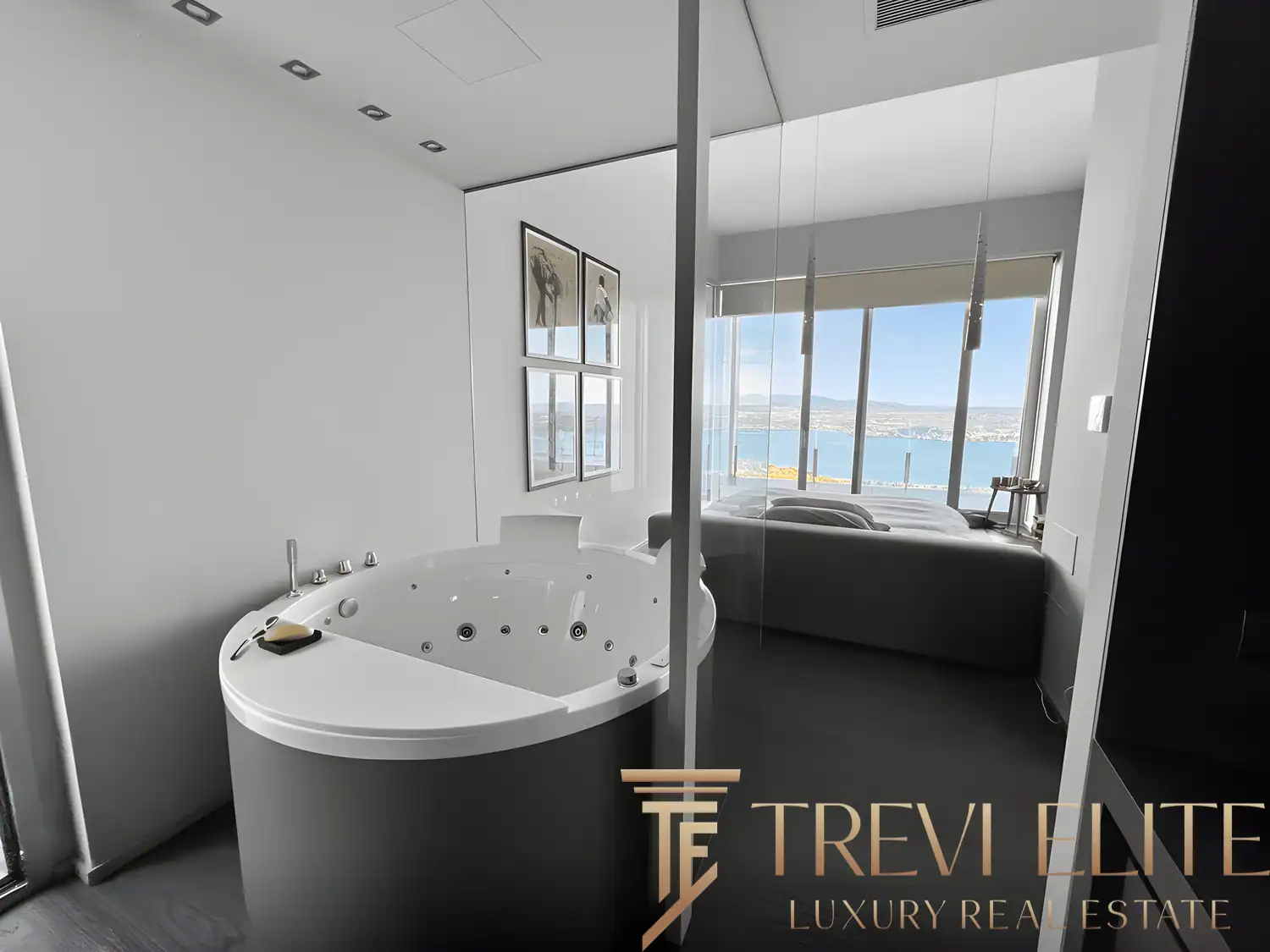 Integrated whirlpool bath positioned in front of a panoramic window.