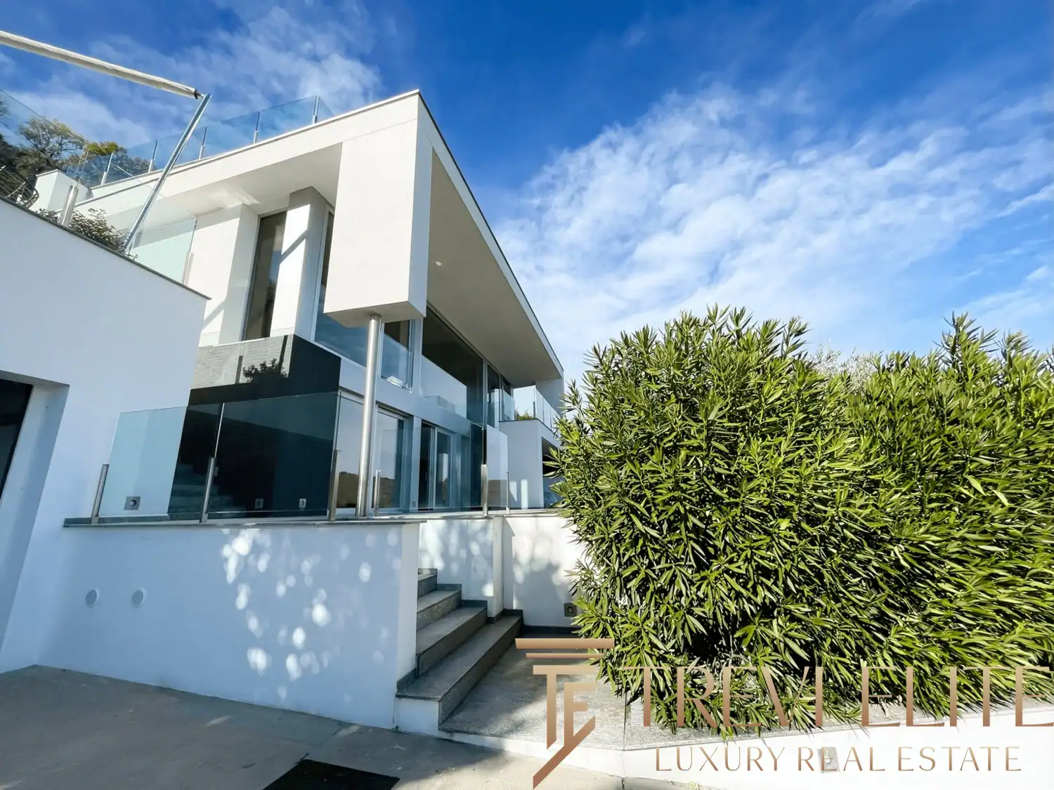 Exterior view of the villa's geometric levels and white stucco finish.