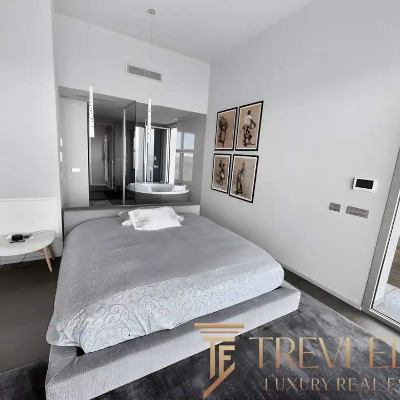 Bright contemporary bedroom with sleek white walls and direct terrace access.