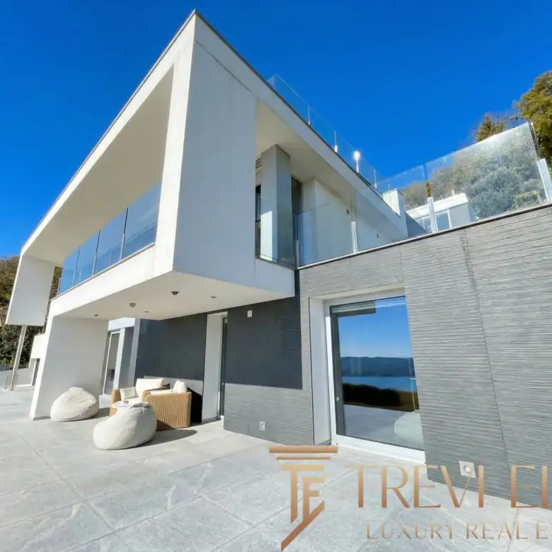 Exterior shot of the villa featuring the rooftop infinity pool and glass railings.