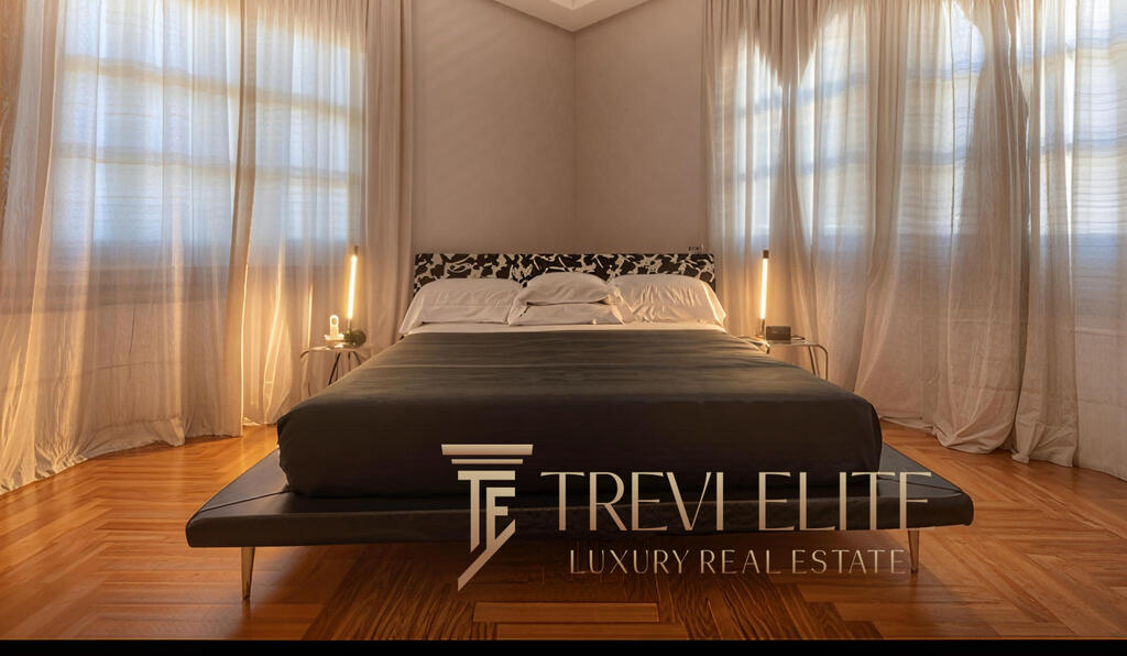 Luxurious master bedroom featuring elegant curtains, modern bedside lamps, and sleek bedding in a sophisticated Italian estate by Trevi Elite.