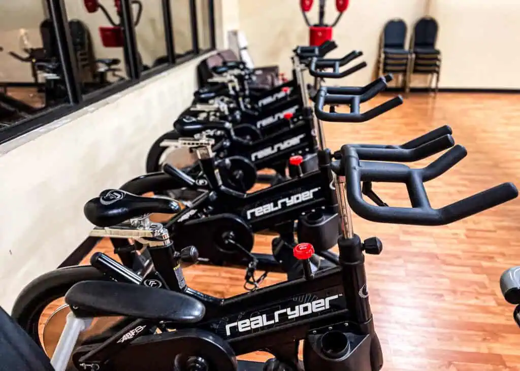 RealRyder indoor cycling bikes lined up in the Triangle Fitness class studio.