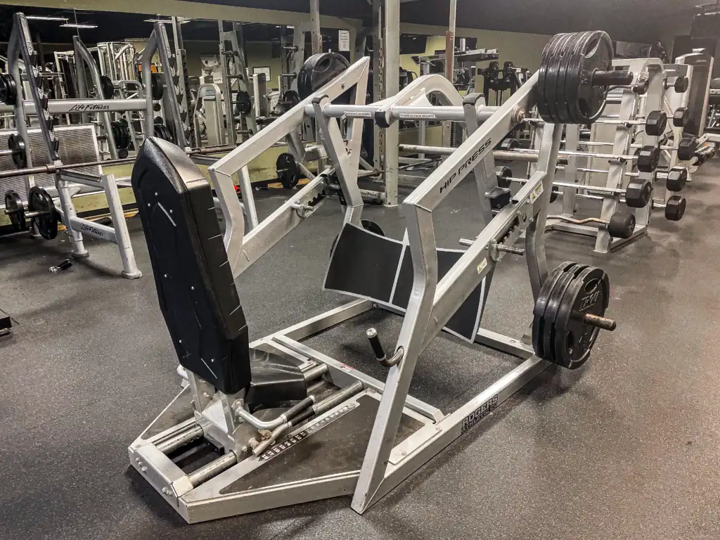 A plate-loaded Rogers hip press machine in the Triangle Fitness weight room.
