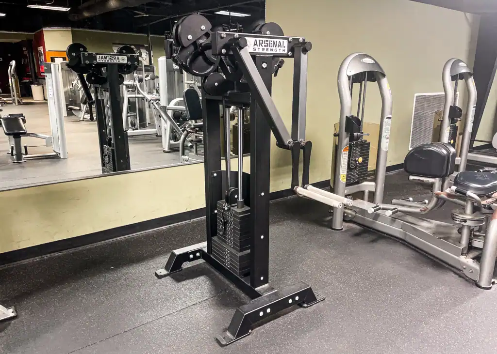 Arsenal Strength plate-loaded machine positioned in the Triangle Fitness weight room.