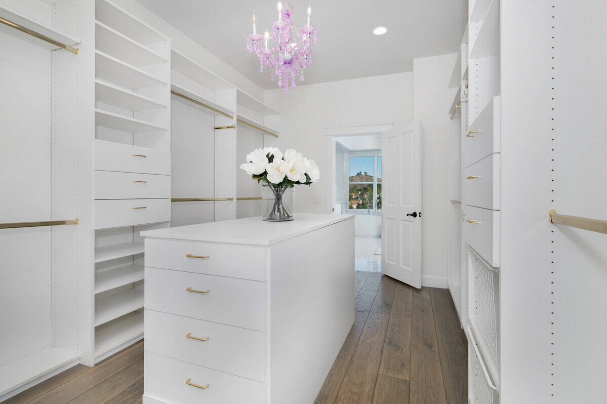 White closet with open shelves and a large countertop