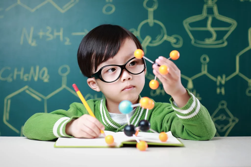 child holding a molecular model