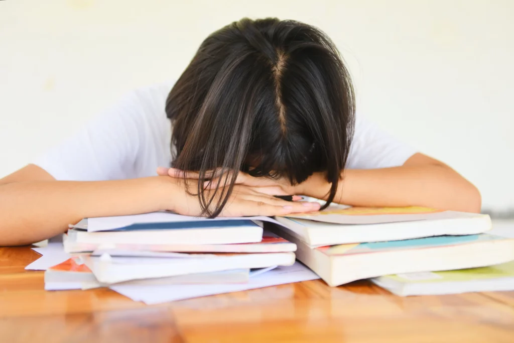 a student on top of her notes for different subjects