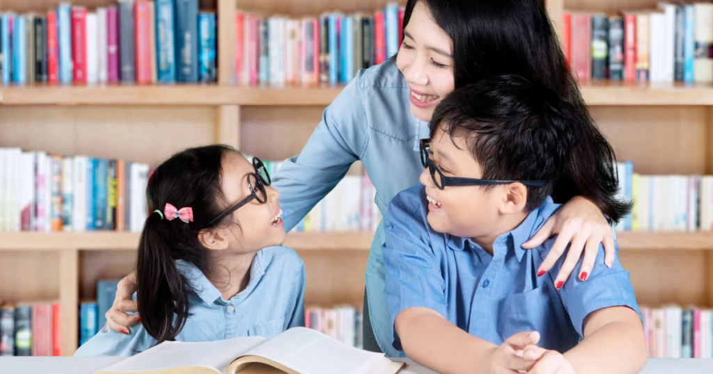 female tutor with two students 
